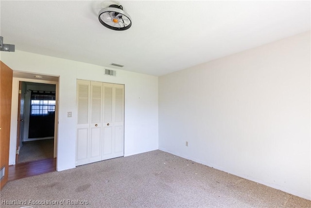 unfurnished bedroom featuring carpet and a closet