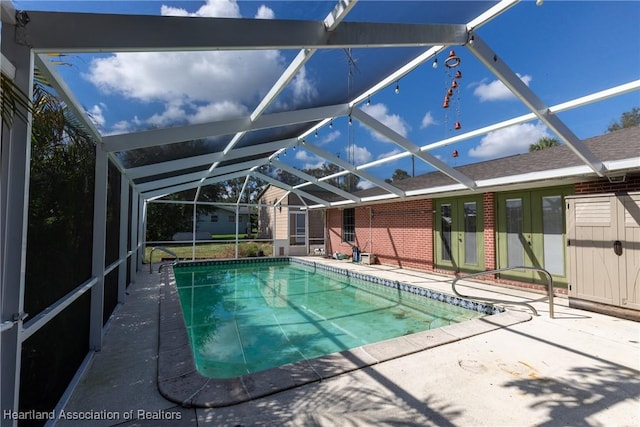 view of pool with a patio area and a lanai