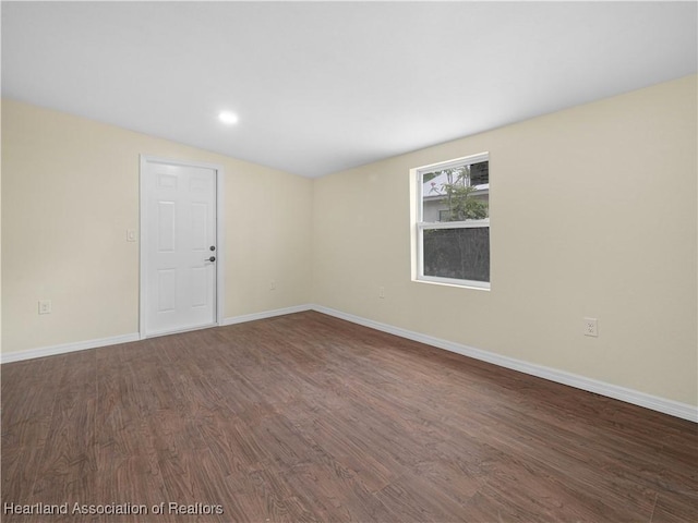 804 S 8th Ave, Wauchula, FL 33873 - empty room featuring dark wood finished floors and baseboards