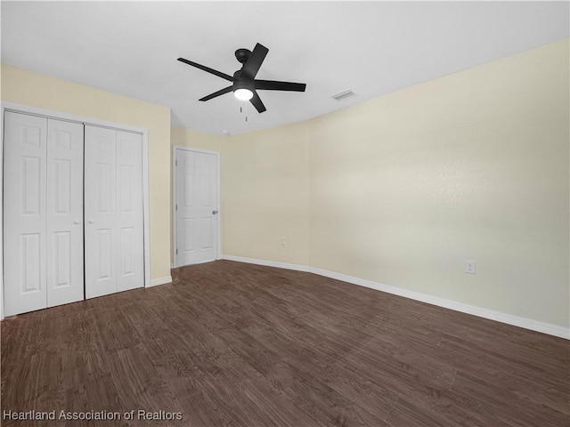 804 S 8th Ave, Wauchula, FL 33873 - unfurnished bedroom featuring a closet, dark wood-type flooring, baseboards, and visible vents
