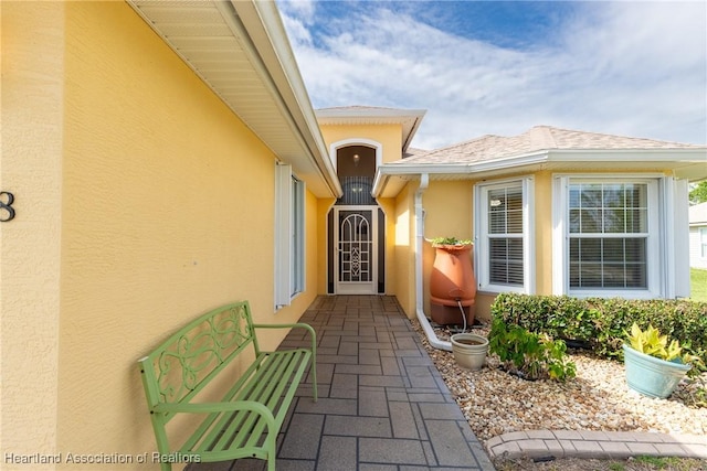 3108 Oakmont Dr, Avon Park, FL 33825 - view of exterior entry with roof with shingles and stucco siding