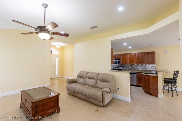3108 Oakmont Dr, Avon Park, FL 33825 - living area featuring light tile patterned floors, baseboards, a ceiling fan, and visible vents