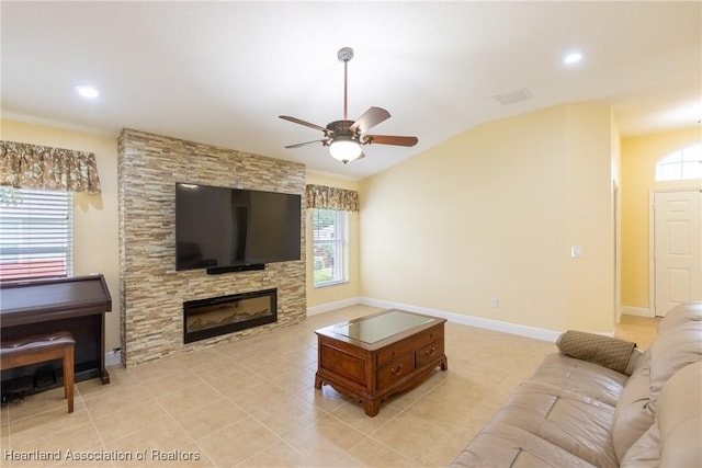 3108 Oakmont Dr, Avon Park, FL 33825 - living room featuring light tile patterned floors, a ceiling fan, a stone fireplace, lofted ceiling, and baseboards
