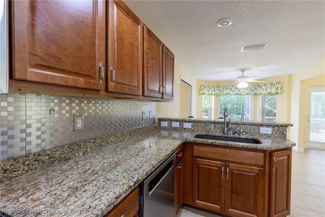 3108 Oakmont Dr, Avon Park, FL 33825 - kitchen featuring a peninsula, backsplash, light stone countertops, dishwasher, and a sink