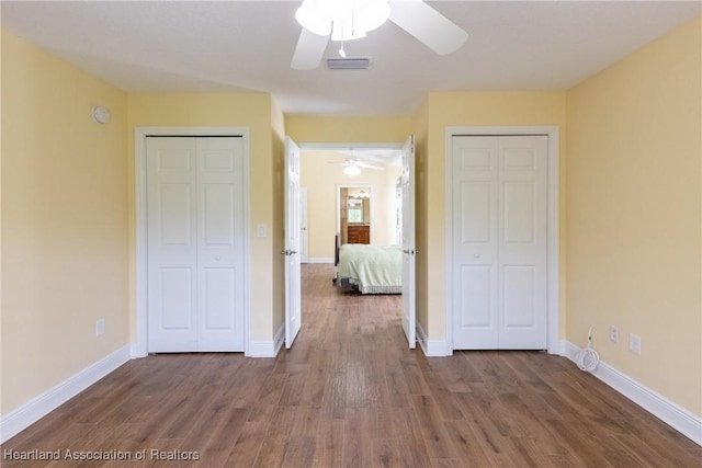 3108 Oakmont Dr, Avon Park, FL 33825 - unfurnished bedroom with visible vents, baseboards, multiple closets, and wood finished floors