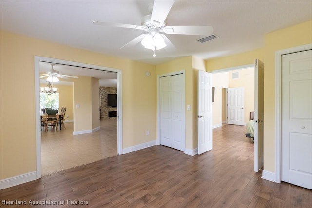 3108 Oakmont Dr, Avon Park, FL 33825 - interior space with ceiling fan with notable chandelier, wood finished floors, and visible vents