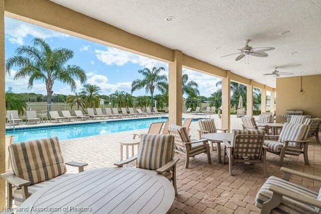 1624 Marble St, Sebring, FL 33870 - community pool with a patio area, outdoor dining space, and a ceiling fan