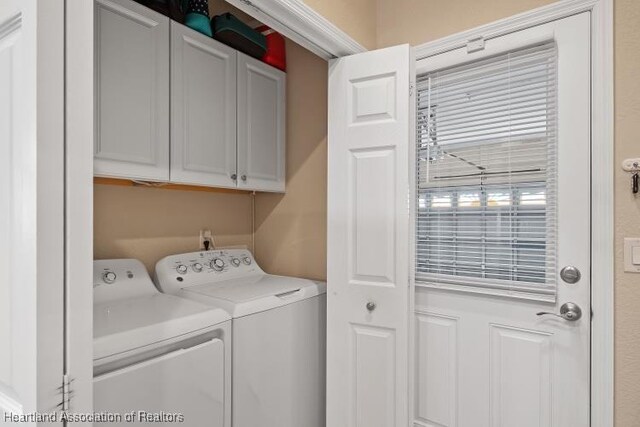 1624 Marble St, Sebring, FL 33870 - laundry area featuring cabinet space and washing machine and dryer