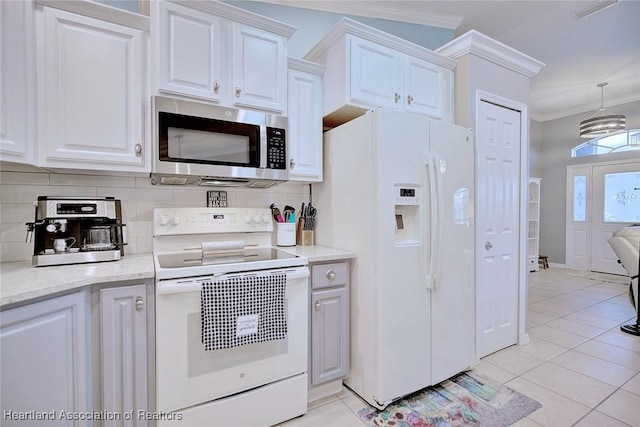 kitchen with light tile patterned floors, white appliances, white cabinetry, decorative backsplash, and crown molding