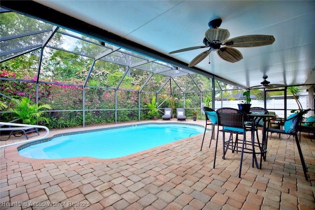 pool featuring ceiling fan, a patio, and a lanai