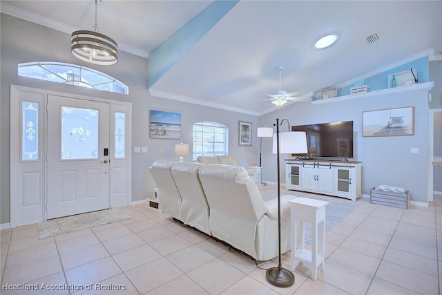 living room featuring light tile patterned floors, lofted ceiling, ornamental molding, baseboards, and ceiling fan with notable chandelier