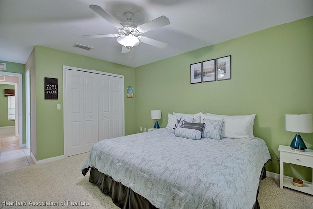 bedroom featuring carpet floors, a closet, visible vents, and baseboards