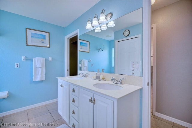 full bathroom featuring double vanity, a sink, and tile patterned floors