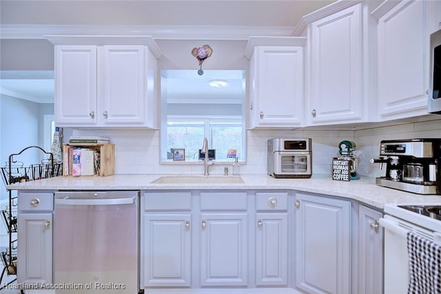 kitchen featuring crown molding, appliances with stainless steel finishes, a sink, and white cabinets