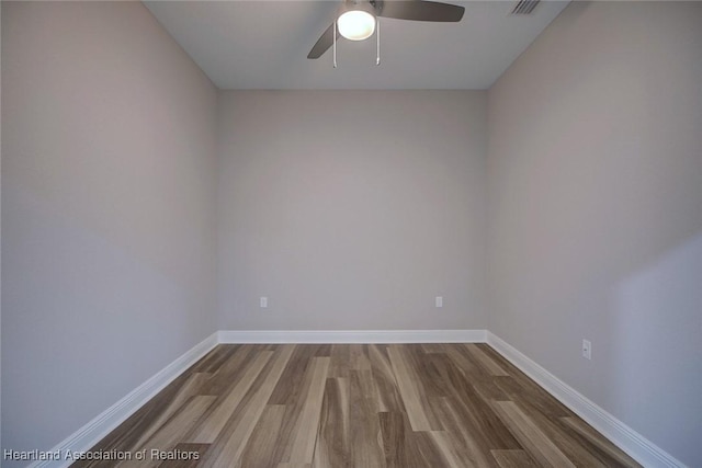 spare room with wood-type flooring and ceiling fan