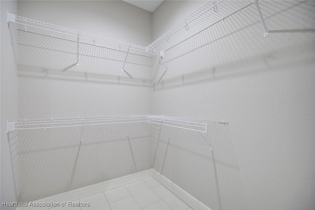 walk in closet featuring tile patterned flooring