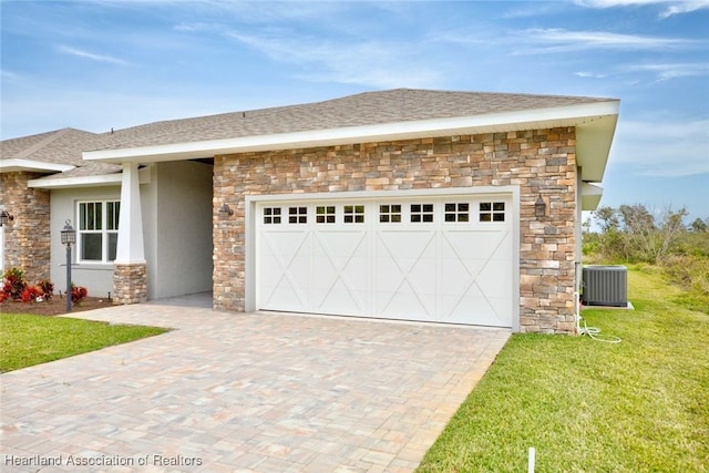 view of front facade featuring cooling unit, a garage, and a front lawn