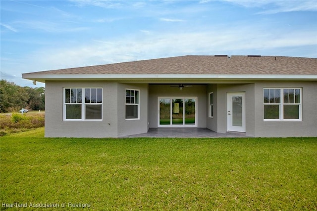 rear view of house featuring a patio and a yard