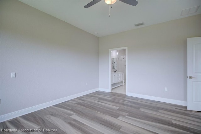 spare room featuring light wood-type flooring and ceiling fan