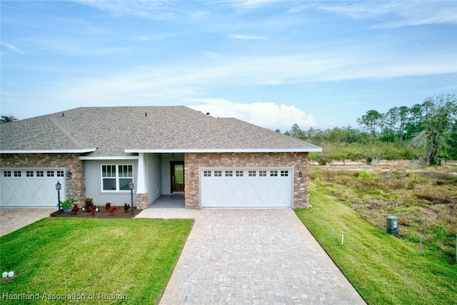 single story home featuring a garage and a front lawn