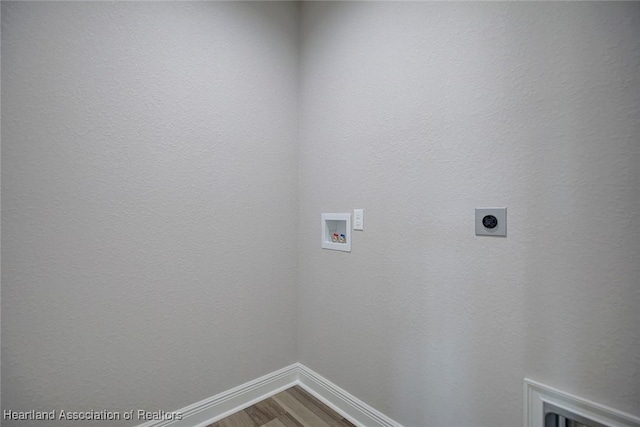 washroom featuring washer hookup, hardwood / wood-style flooring, and hookup for an electric dryer