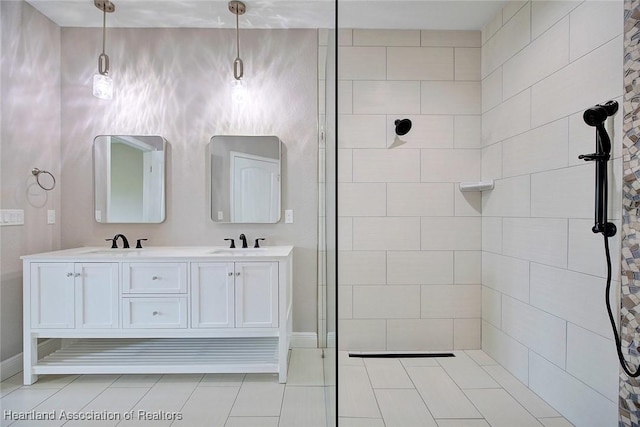 bathroom featuring a tile shower and vanity