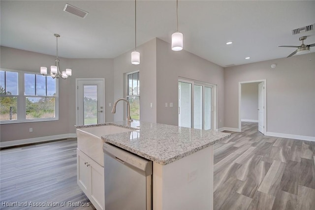 kitchen featuring white cabinetry, a kitchen island with sink, stainless steel dishwasher, sink, and decorative light fixtures