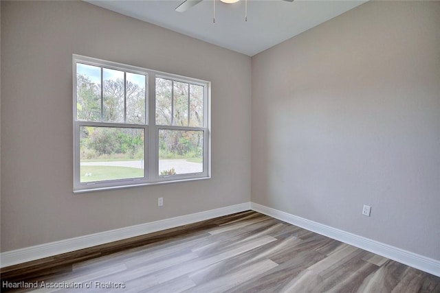 spare room with ceiling fan and light hardwood / wood-style flooring