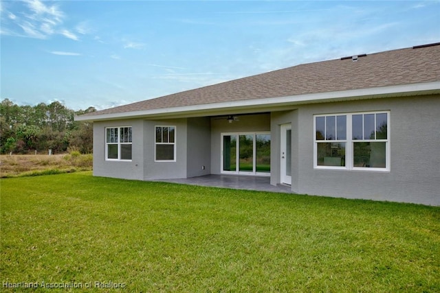 back of house with ceiling fan, a patio, and a yard