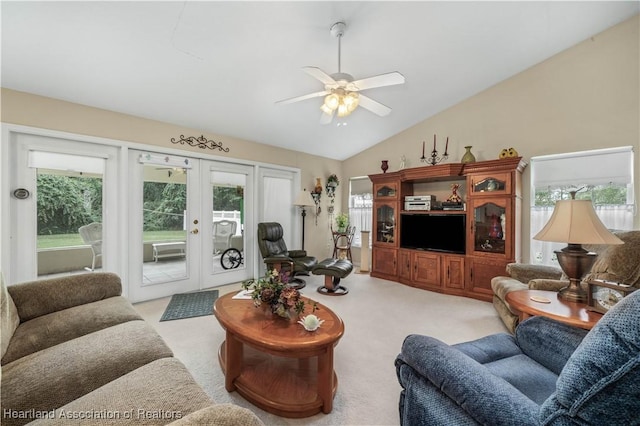 carpeted living room featuring french doors, vaulted ceiling, and ceiling fan