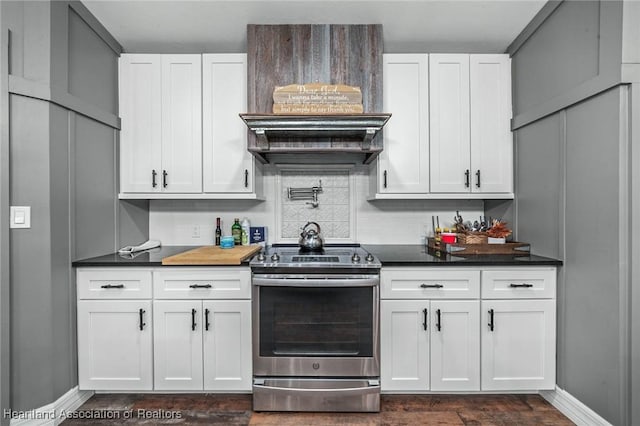 kitchen with tasteful backsplash, dark countertops, white cabinets, and stainless steel range with electric cooktop