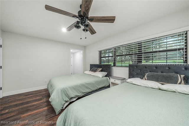 bedroom featuring ceiling fan, baseboards, and wood finished floors