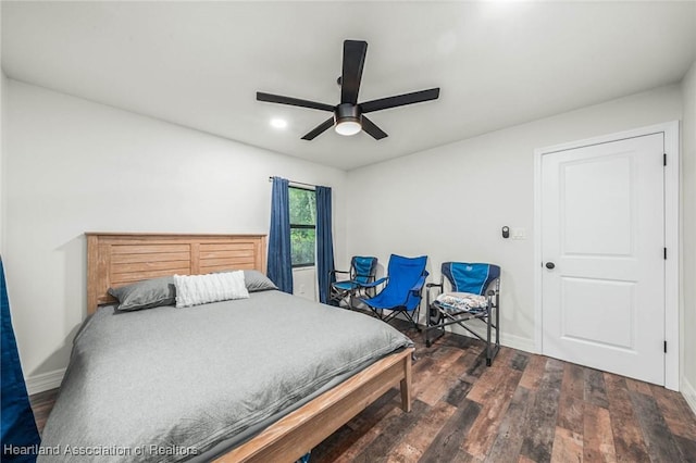 bedroom with wood finished floors, a ceiling fan, and baseboards