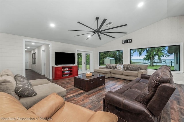 living room featuring vaulted ceiling, visible vents, dark wood finished floors, and french doors