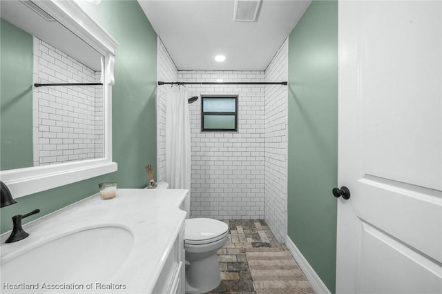 bathroom with recessed lighting, visible vents, toilet, a shower stall, and vanity