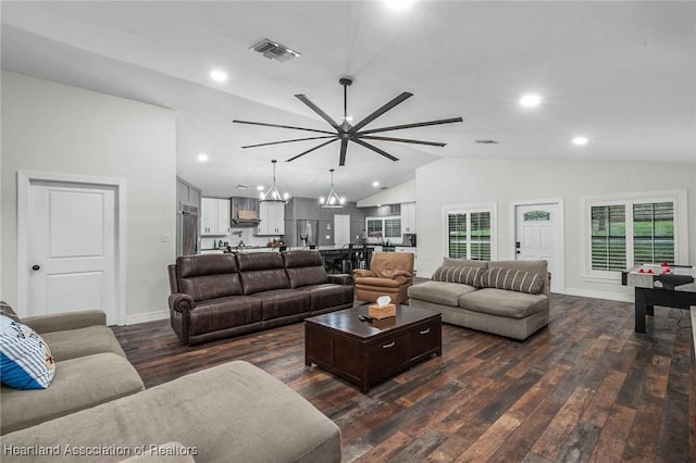 living room featuring visible vents, an inviting chandelier, dark wood-type flooring, vaulted ceiling, and baseboards