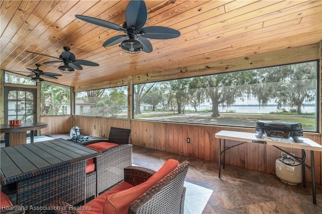 sunroom / solarium with ceiling fan and wood ceiling