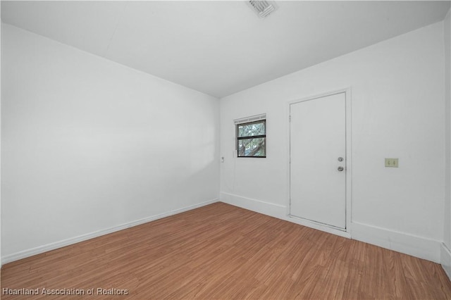 unfurnished room with hardwood / wood-style floors