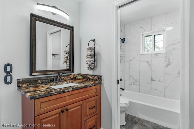 full bathroom with vanity, toilet, and tiled shower / bath