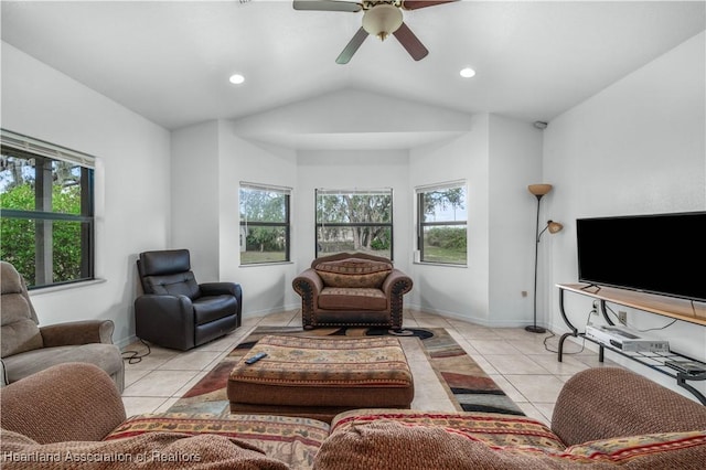 tiled living room featuring ceiling fan and lofted ceiling