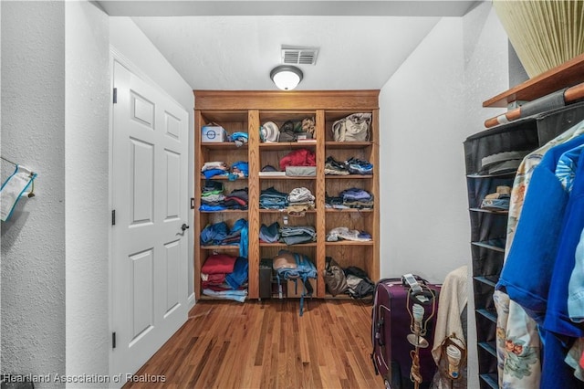 walk in closet featuring hardwood / wood-style flooring