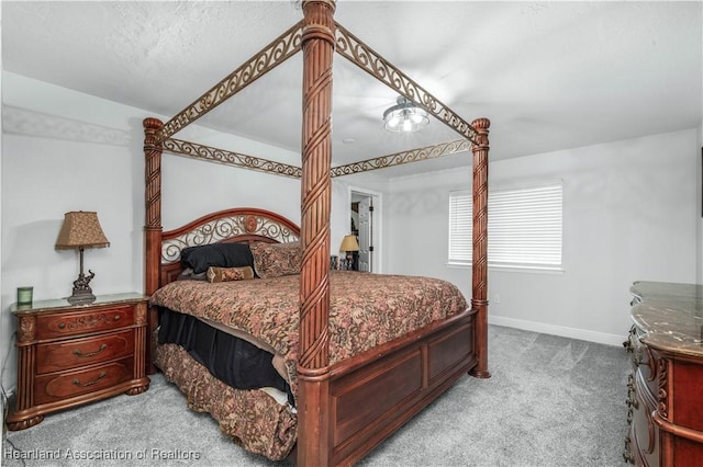 carpeted bedroom featuring a textured ceiling