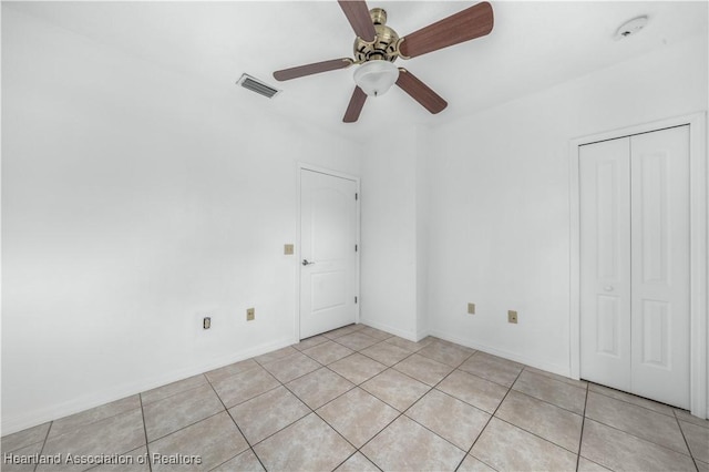 spare room featuring light tile patterned floors and ceiling fan