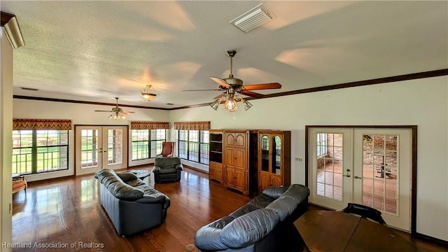 living room with french doors, ornamental molding, ceiling fan, wood finished floors, and healthy amount of natural light