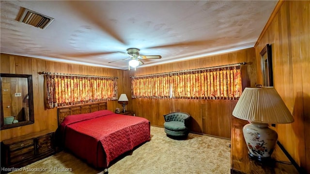 bedroom featuring wooden walls and a ceiling fan