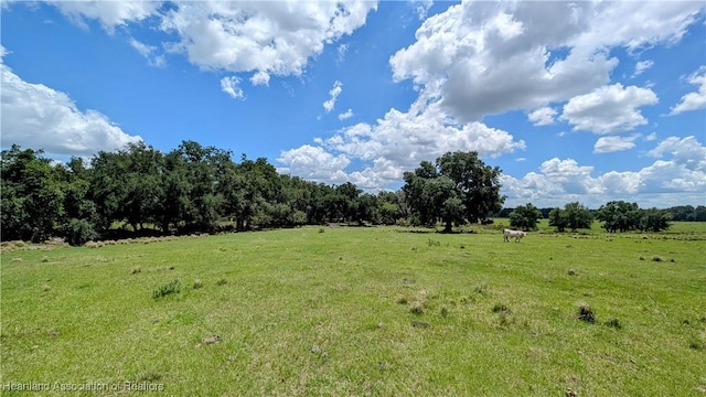view of green lawn with a view of countryside