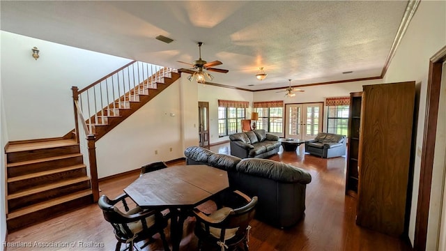 living area featuring ceiling fan, wood finished floors, stairway, ornamental molding, and baseboards