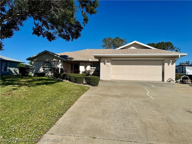 single story home featuring a garage and a front lawn