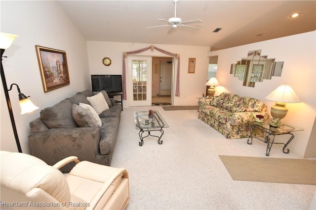 living room with ceiling fan, carpet floors, and lofted ceiling