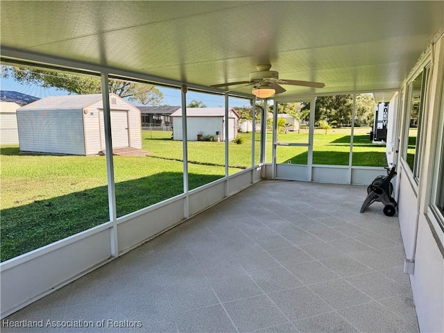 unfurnished sunroom featuring ceiling fan